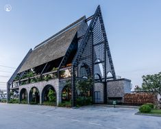 an unusual building with plants growing on the roof