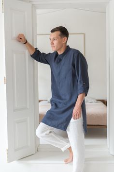 "A classic style redefined with modern styling, we created a linen tunic for men to fill that gap in your everyday wardrobe. The linen shirts are breathable and durable to provide maximum comfort, and they've kept it simple with roll-up sleeves and button-up closure. Step out in style no matter the occasion with a little help from our signature linen tunic. Handmade by masters of their craft in Lithuanian, where skills have been passed down for generations, your wardrobe's latest addition is sur Tunic Designs Men, Relaxed Fit Long Sleeve Linen Kurta, Summer Linen Kurta With Relaxed Fit, Spring Linen Kurta With Relaxed Fit, Casual Linen Kurta With Relaxed Fit, Casual Linen Kurta For Summer, Summer Linen Kurta Tunic, Summer Linen Tunic Kurta, Casual Linen Kurta Tunic