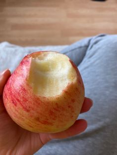 a person holding an apple in their hand