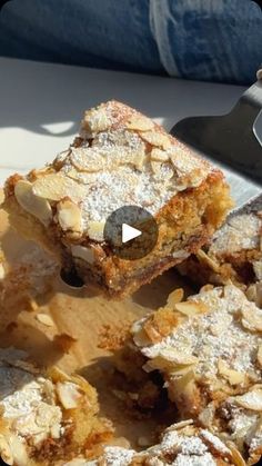 several pieces of dessert sitting on top of a cutting board