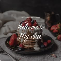 a plate topped with pancakes covered in whipped cream and berries