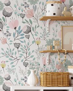 the wallpaper in this room is painted with flowers and leaves, as well as shelves