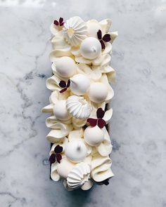 an overhead view of some white chocolates on a marble counter top with red and white decorations