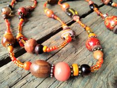 "------------------------------------------------------------------- Long Orange Necklace handmade by reccabella ------------------------------------------------------------------- This long necklace is a great piece, I have made it from hundreds of different beads in various shades of orange. The mixture of materials such as wood, glass, ceramic etc makes this a really interesting necklace. The variations of shade also adds to the uniqueness of the piece. I have added some antique bronze effect Interesting Necklace, 30th Birthday Gift, Necklace Orange, Orange Necklace, Surfer Necklace, Wood Bead Necklace, Long Silver Necklace, Buy Earrings, Wooden Necklace