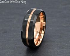 a black and gold wedding ring with two bands