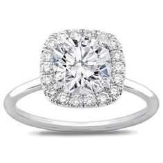 an engagement ring with a cushion cut diamond in the center