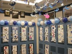 the lockers are decorated with blue, white and pink balloons hanging from the ceiling