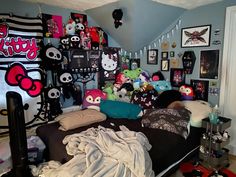 a room filled with lots of stuffed animals and pictures on the wall above it's bed