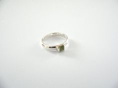 Overview:Offered for sale is a wonderful Tiffany and Co. Sterling Silver Peridot Green Gemstone stacking ring.   Looks very feminine and pretty on the fingers, this ring is surely one that you will turn to over and over again.  It is elegant, very versatile, and extremely comfortable to wear.   This wonderful piece is sizable and is in very good condition.  Perfect ring to start or add to your Tiffany collection. The ring is fully hallmarked and is guaranteed to be 100% authentic.

It will com Green Gemstone Stackable Promise Rings, Modern Green Gemstone Stackable Rings, Green Stackable Open Ring For Promise, Stackable Peridot Rings For Anniversary, Stackable Rings With Rectangular Stone For Anniversary, Anniversary Stackable Rings With Rectangular Stone, Modern Green Stackable Rings, Green Sapphire Stackable Ring For Gift, Stackable Green Sapphire Ring Gift