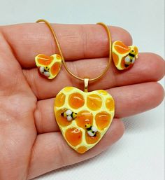 Beautiful and unique  honeycomb jewelry made in the shape of a heart with miniature bees! A great piece for summer wear and lover's of the honey bee. Takes a couple of days to make and then they're shipped out. Handmade with clay and resin to be a whole set or individual pieces of jewelry. The gold necklace chain is stainless steel and 20in long. The gold stud backings are stainless steel as well. The ring is gold alloy and is adjustable. The ring will also have a choice if you want the big heart or the little heart. Set includes: Ring,studs and necklace! Thankyou and happy summer days! Heart Gold Necklace, Honeycomb Jewelry, Bee Heart, Mini Sculptures, Gold Necklace Chain, Real Jewelry, Gold Alloys, Gold Heart Necklace, Earrings Studs