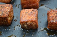 several cubes of food sitting on top of a pan