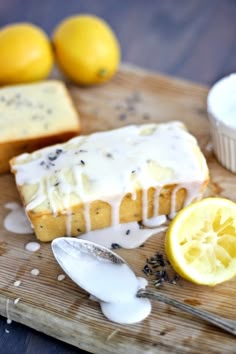 a loaf of lemon poppy seed bread on a cutting board next to some sliced lemons