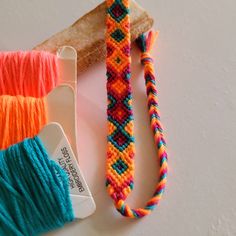 two skeins of yarn next to a piece of bread