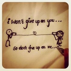 someone is writing on a t - shirt that says i won't give up on you