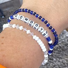 🏈 Who loves football? Are you a Cowboys fan? Show your team spirit with this fun bracelet set! Great for gift giving!! Lightweight and oh so comfy to wear. I added faceted crystals to make them super sparkly! You will receive 3 bracelets that are made on strong stretch cord and made to fit a 7 1/2" wrist. Need a different size? Just let me know your wrist size and I will be happy to custom make for you! Each piece is handmade with: - High Quality Glass Seed Beads - Faceted Rondelle Crystals - White/Black Acrylic Cube Letter Beads - Stretch Cord: High-quality cord with reinforced knots Easily layer with other Luna by Rachel bracelets for a stunning stack! My pieces are made sturdy, but as with all jewelry, they are also delicate and should be treated with care. Be sure to check out other d Dallas Cowboys Bracelets, Personalized White Beaded Bracelets For Football Season, Dallas Cowboy Bracelet, Tiny Bead Bracelet, Small Bead Bracelet, Crystals White, Stack Bracelets, Fun Bracelet, Bracelet Ideas