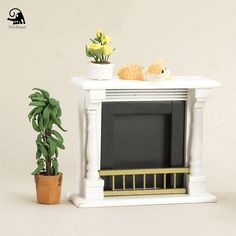 there is a small tv on the stand next to a houseplant and a potted plant