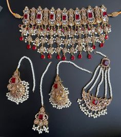 heavy bridal necklace for bride/Antique Traditional Choker for reception/Indian jewellery This complete semi bridal set comes with a gorgeous necklace in 2 finishes and color and matching tikka,passa,earrings. The pink has a silver finish along with pastel pink stones and the red has a maroon stone with antique gold finish. Heavy Red Lehenga For Reception, Red Jhumkas With Intricate Design For Wedding, Red Festive Necklaces For Marriage, Festive Red Necklaces For Marriage, Festive Red Necklace For Marriage, Red Kundan Jewelry For Marriage, Traditional Red Jewelry Sets For Marriage, Red Kundan Bridal Necklace For Reception, Red Meenakari Bridal Necklace For Wedding