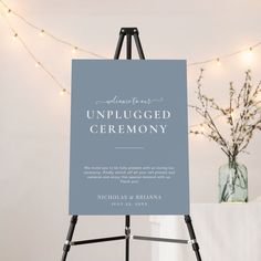 an unplugged ceremony sign is displayed in front of a table with flowers