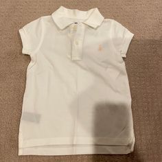 Brand New, Never Worn, Comes With Tags! White With Two Buttons And Collared. Light Pink Logo. 100% Cotton. Ralph Lauren, Girls’ Size 4/4t Cute Ralph Lauren Summer Tops, White Cotton Ralph Lauren Top, Cute Summer Tops By Ralph Lauren, White Fitted Ralph Lauren T-shirt, Fitted White Ralph Lauren T-shirt, Ralph Lauren Fitted White T-shirt, Cute White Ralph Lauren Top, White Ralph Lauren Summer Top, Cute Fitted Ralph Lauren Tops