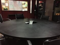 a conference table with two remote controls on it