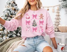 This girly Christmas sweatshirt in pink is perfect for those looking for a funky and coquette vibe during the holiday season. It offers a cozy and comfortable wearing experience, making it ideal for colder months. This sweatshirt is relevant to those who enjoy festive and stylish clothing for Christmas celebrations. Product features - Knit in one piece without side seams for reduced fabric waste - Ribbed knit collar with seam for elasticity and shape retention - Medium-heavy fabric blend of 50% cotton and 50% polyester for warmth - Classic fit with crew neckline for a clean-cut style - Ethically made with 100% US cotton and OEKO-TEX-certified dyes for sustainability Care instructions - Machine wash: cold (max 30C or 90F) - Non-chlorine: bleach as needed - Tumble dry: low heat - Do not iron Soft Girl Christmas, Coquette Sweatshirt, Coquette Christmas, Pink Bows, Winter Walk, Girl Christmas, Gingerbread Men, Mens Long Sleeve Tee, Cozy Sweater