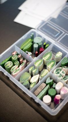 a plastic container filled with lots of different types of candies on top of a table