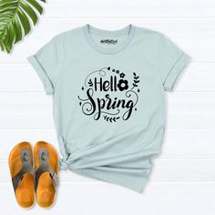 Hello Spring Shirt, spring shirts for women, Easter Shirts, Floral Spring T-Shirt, Spring Flowers Shirt, spring day t-shirt, spring clothing Hello! Thank you for supporting small businesses. My main priority here is the satisfaction of my customers. My t-shirts are Bella+Canvas brand. If Bella+Canvas is out of stock, I will send it from a brand of the same size and quality. If you want to see this design on the SWEATSHIRT you can buy it from the link below.https://etsy.me/3LS0Viz T-shirts are co Spring Letter Print Short Sleeve T-shirt, Green Casual T-shirt For Spring, Trendy Spring Tops With Letter Print, Spring Graphic Tee Cotton Tops, Spring Cotton Graphic Tee Tops, Spring Crew Neck Graphic Tee, Spring Cotton T-shirt With Graphic Print, Spring Graphic Tee With Crew Neck, Spring Letter Print T-shirt With Relaxed Fit