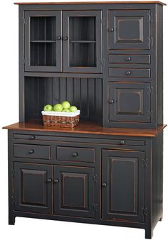 an old style hutch with fruit on top