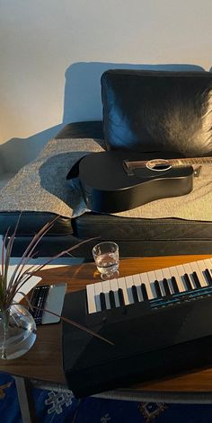 an electronic keyboard sitting on top of a wooden table