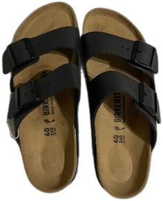 Classic Black Open Toe Footbed Sandals, Classic Black Footbed Sandals With Buckle Closure, Black Flat Slides With Cork-bed Midsoles, Casual Black Leather Footbed Sandals, Casual Black Footbed Sandals With Leather Footbed, Classic Black Footbed Sandals For Beach, Classic Black Footbed Sandals With Leather Footbed, Black Closed Toe Slides With Buckle Closure, Classic Black Sandals With Cushioned Footbed