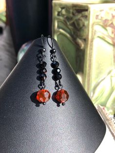 "These simple but elegant earrings were made to match the Black Red Orange Multi Strand Art Deco Style Necklace w/ Heart Pendant Pendant and Bracelet. Made with jet black 4mm round crystals and 8mm round faceted round crystals. Black coated brass ear hooks. Length: 1 7/8\" Matching pieces available: Heart Pendant Necklace: https://www.etsy.com/listing/896700815/black-red-orange-multi-strand-art-deco Bracelet https://www.etsy.com/listing/898954585/black-red-orange-multi-art-deco-style" Strand Art, Crystals Black, Art Nouveau Earring, Art Deco Bracelet, Deco Earrings, Earrings Art, Vintage Style Earrings, Orange Earrings, Art Deco Earrings