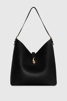 The Megan Hobo is the ideal go-to bag for those seeking effortless style and functionality. Crafted from genuine leather, this spacious hobo is designed to fit all your essentials while maintaining a sleek and modern silhouette. Its magnetic snap closure and antique brass hardware add a touch of sophistication, making it a perfect choice for everyday wear. Style # HH24TMGHOB-BLACK Genuine Leather Antique Brass Hardware 13" W X 14. 5" H X 6. 25" D 23" Strap Drop Magnetic Snap Closure 1 Back Zip Pocket Black Nappa PU Lining Imported The photos featuring a model are for size reference only. Actual color and material may vary from what is depicted. | Rebecca Minkoff Megan Hobo Bag In Black Leather Outerwear, Female Founders, Antique Brass Hardware, Leather Dresses, Hobo Handbags, Brass Hardware, Hobo Bag, Handbag Accessories, Shoe Collection