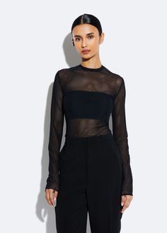 Solid mesh long sleeve top with mock neck. True to size. Material: 85% Polyamide, 15% Elastane Care: Machine Wash or Dry Clean Night Out Long Sleeve Top, Black Fitted Long Sleeve Top Outfit, Sheer Top Styling, Mesh Clothing Women, Mesh Black Top Outfit, Long Sleeve Mesh Top Outfit, Black Transparent Top Outfit, Mesh Top Outfit Aesthetic, Mesh Undershirt Outfit