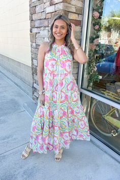 A floral maxi with pops of pink, green, and blue to brighten up your look! Marvel Dress, Spring Vacation, Trendy Boutique, Fringe Sweater, And July, Red Jumpsuit, Chic Boutique, Floral Maxi