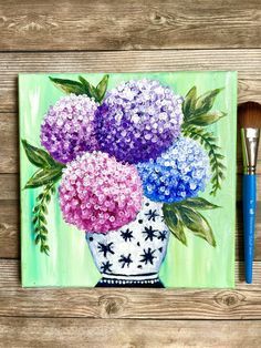 a painting of purple and blue hydrangeas in a white vase