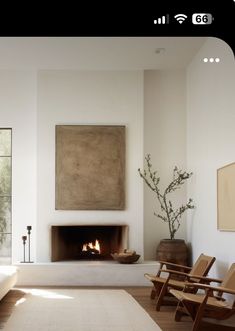 a living room filled with furniture and a fire place next to a painting on the wall