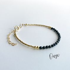 This beautiful black onyx gemstone bracelet is handcrafted with 4mm natural black onyx beads. The gold beading is done with high quality Japanese Miyuki Duracoat delica seed beads. The larger round gold beads are 14k gold filled for lasting quality. A 14k gold filled spring clasp completes the look. It's the perfect bracelet for layering or wearing all on its own! It's simple, yet elegant design makes it a great option for every day wear. This bracelet can be purchased in either 14k gold filled Elegant Beads Bracelet, Adjustable Onyx Beaded Bracelets, Minimalist Onyx Beaded Bracelets With Round Beads, Dainty Black Beaded Bracelets For Gift, Minimalist Onyx Beaded Bracelet With Round Beads, Minimalist Onyx Beaded Bracelet, Adjustable Onyx Beaded Bracelets With Polished Beads, Adjustable Black Bracelets With Gold Beads, Minimalist Adjustable Jewelry With Black Beads