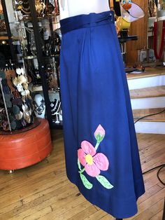 Hand Crafted Wrap Around Skirt, Royal Blue Cotton Skirt with pink Floral Appliqué and Embroidery front and back. Women's medium. Could extend to large. In good used condition! Traditional Wrap Skirt For Spring, Fitted Blue Skirt With Floral Embroidery, Long Blue Embroidered Skirt, Blue Embroidered Long Skirt, Blue Cotton Skirt, Prom Purse, Leisure Suit, Beaded Evening Bags, Bridal Clutch