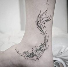 a woman's foot with a tattoo on it