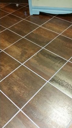 a brown tile floor with white lines on it