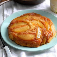 a plate that has some kind of cake on it with apples in the middle and another dish next to it