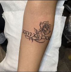 a woman with a tattoo on her arm that says, xxvixilix