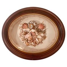 a bowl filled with sea shells on top of a table