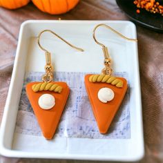 two pieces of food are sitting on a tray next to pumpkins and other decorations