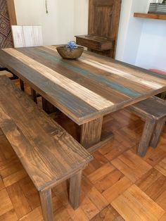 a wooden table and bench in a room