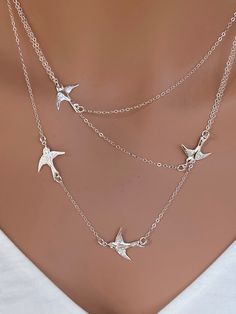 "A beautiful flying birds necklace. It combines 4 birds on different lengths chains. The necklace are lightweight and easy to wear . All 3 layers wt 4 birds are stayed by one spring clasp, so they are attached. It comes wt 1\" extender at the end of necklace . ★ ★ ★ IT consists of ... -20.1x17mm Bird Sterling silver or Gold Fill, -dainty and strong chain in sterling silver, gold filled or rose gold filled, -Come up with beautiful ribbon gift box and -One set of Care instruction package. MORE LAY Silver Multi-strand Charm Necklaces As Gift, Silver Multi-strand Charm Necklace As Gift, Silver Multi-strand Charm Necklace For Gift, Elegant Silver Necklace With Bird Shape, Silver Multi-strand Dainty Charm Necklace, Multi-strand Clavicle Chain Layered Necklace As Gift, Ribbon Gift, Flying Birds, Flying Bird