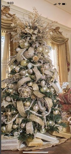 a christmas tree decorated with silver and gold ornaments