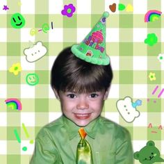 a young boy wearing a green shirt and tie with a party hat on his head