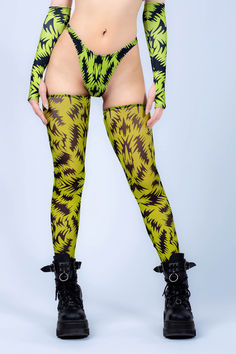 Add a pop of electrifying green into your rave wardrobe. This striking design features a daring cutout at the chest, complemented by a chic bandeau style and an elegant high neckline adorned with an intricate pattern, making it a must-have addition to your collection. Team up with the matching gloves and leg warmers, top it off with your favorite pair of boots and your favorite dark shades.