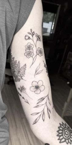 a person with a flower tattoo on their arm